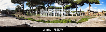 Ostia Antica Rome, Italy - February 03, 2019:Panoramic view of the Roman empire ruins in Ostia Antica looking from the marble of ancient theatre towar Stock Photo