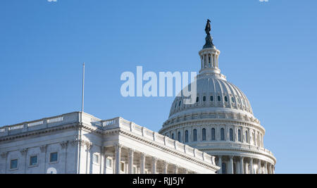 Side view of the US Capitol Building in Washington, D.C. with a bright blue sky. Stock Photo