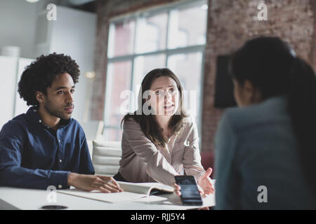 Smartphone app developers in a business meeting Stock Photo
