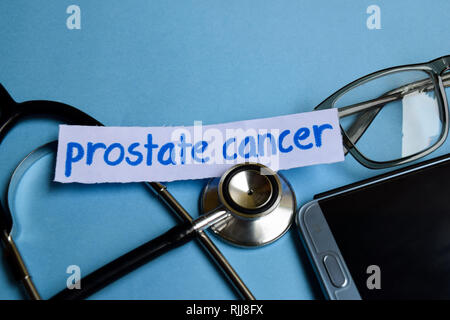 Conceptual image with Prostate cancer inscription with the view of stethoscope, eyeglasses and smartphone on the blue background. Medical Conceptual. Stock Photo