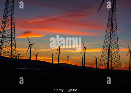 Red sunrise over valley with working wind turbines Stock Photo