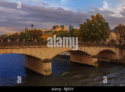 View onto the Seine and the Bridge of the Pont de l'Archeveche or Archbishop's Bridge, famous for love locks near the Notre Dame de Paris cathedral in Stock Photo