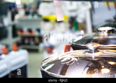 Stainless steel kitchenware set on shelves, shallow depth of field image Stock Photo