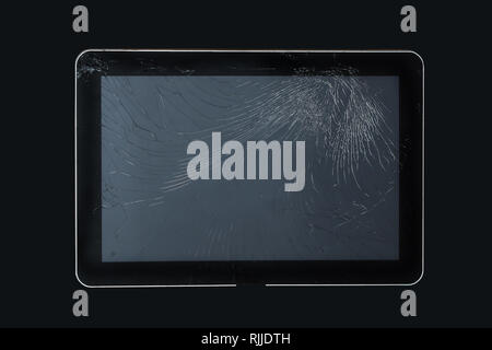 Damaged broken screen glass on modern tablet device isolated on black background with clipping path included Stock Photo