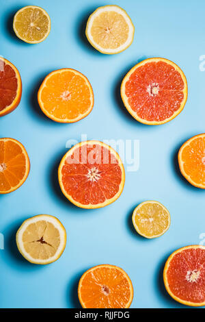cut in half juicy citruses on a blue background Stock Photo