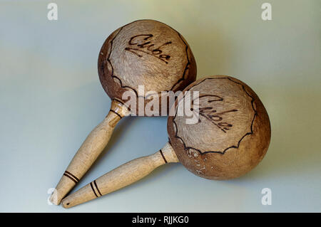 Pair of maracas made of leather and wood with the word Cuba printed, isolated on plain background Stock Photo