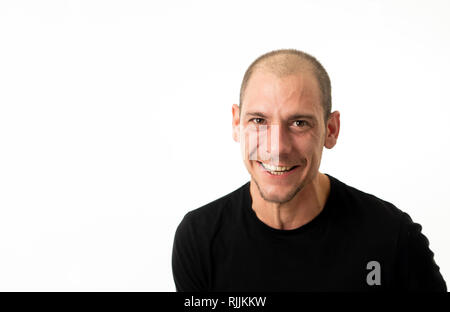 Human emotions and facial expressions. Close up of smiling and laughing young man with happy face expression. People portraits Isolated in neutral bac Stock Photo