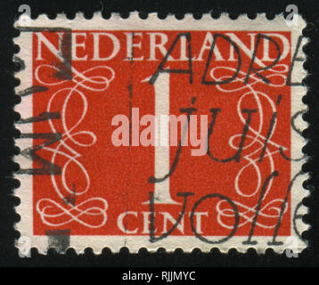 RUSSIA KALININGRAD, 21 JUNE 2017: stamp printed by Netherlands shows emblem, figure, number and symbol, circa 1946 Stock Photo