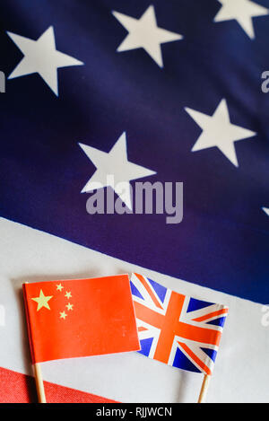 Flags of China and United Kingdom on great American flag, allied world countries. Stock Photo