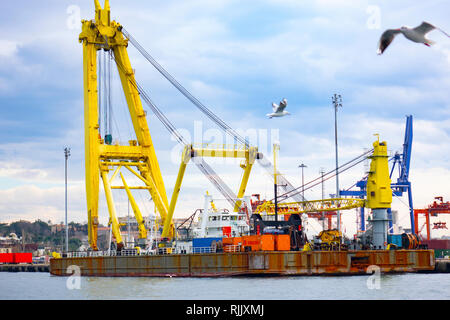 Logistics and transportation of Container Cargo ship and Cargo plane with working crane bridge in shipyard, logistic import export and transport indus Stock Photo