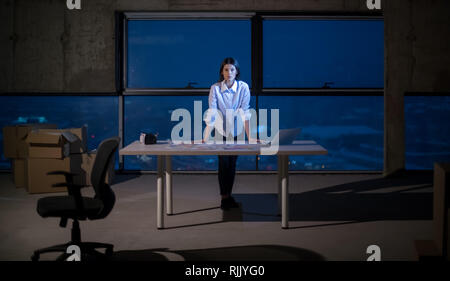 portrait of young female architect on construction site checking documents and business workflow using laptop computer in new startup office Stock Photo