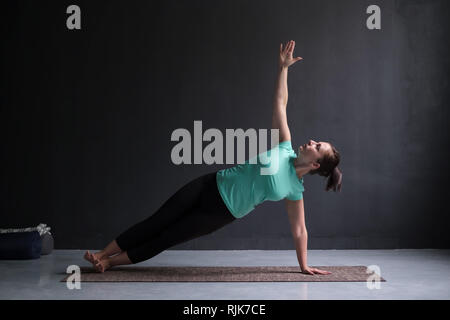 Model doing Side Plank Posture, Pose of Vashista, Vasisthasana Stock Photo