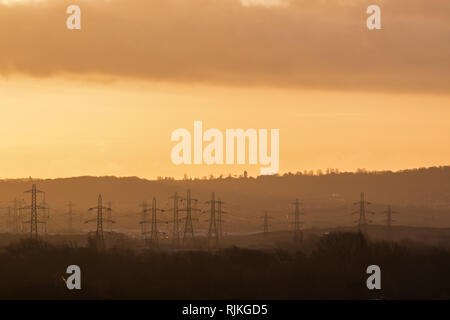 London UK. 7th February 2019. Power station and electricity pylons are silhouetted against a colourful winter sunrise in Wimbledon as the cold weather begin to thaw Credit: amer ghazzal/Alamy Live News Stock Photo