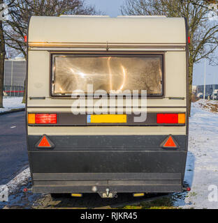 classic old vintage caravan from the back, mobile trailer for traveling on the road Stock Photo