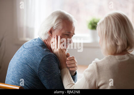 Attractive aged married couple looking with love each other  Stock Photo