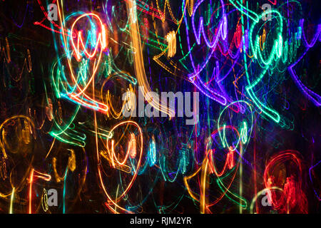 Abstract pattern of multicolored light chaotic strokes on black background. Stock Photo