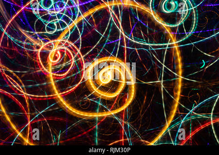 Abstract drawing of glowing multicolored spiral swirls on black background.  Stock Photo