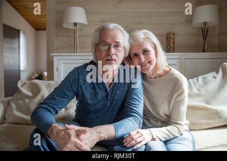 Mature spouses make video call looking at camera Stock Photo