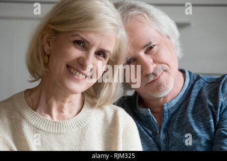 Close up portrait of aged couple smiling looking at camera Stock Photo