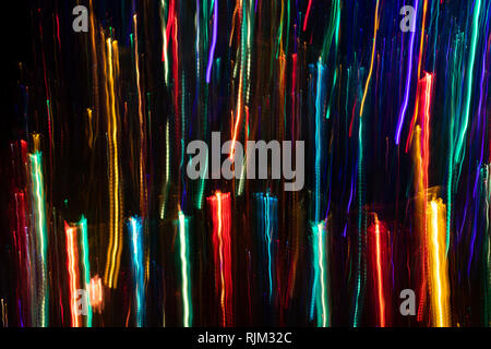 Multicolored vertical thin and thick glowing lines on black backdrop.  Stock Photo
