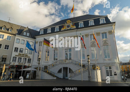 German flag waves against the blue sky in front of the Bundesstadt Bonn - Altes Rathaus, City Hall Government office on Markt square. Germany. Stock Photo