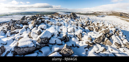 Winter landscape and snow covered scenery from Smearsett Scar in the Yorkshire Dales looking towards Ingleborough and the Lake District Stock Photo