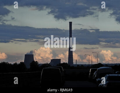 Smokestack and cooling tower of power plant on the edge of town Stock Photo