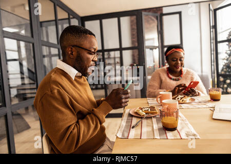Nice serious man using his new smartphone Stock Photo