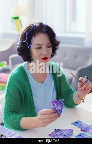 Pleasant nice woman using an aroma stick Stock Photo