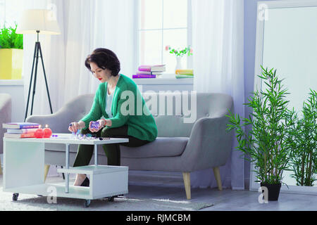 Nice good looking woman practicing magic at home Stock Photo