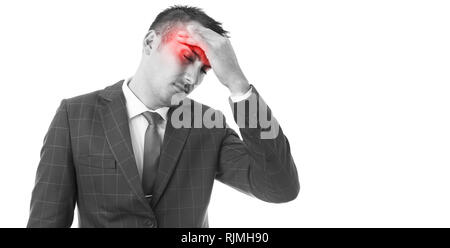 Black and white picture of man wearing business suit touching red painful forehead as headache caused by stress concept Stock Photo