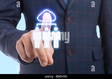 Businessman touching cloud icon on transparent display with index finger as futuristic concept Stock Photo