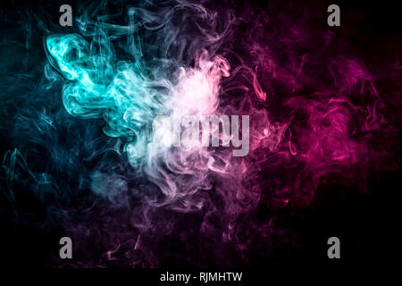 Close up swirling pink and blue smoke on black isolated background Stock Photo