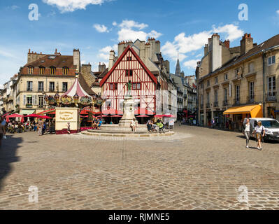 The Place Francois Rude, Dijon, Burgundy, France showing the fountain and the pretty cafe. Also a French merry go round or carrousel in the square. Stock Photo
