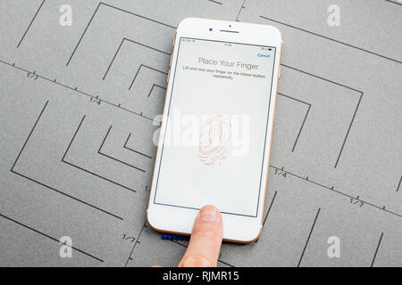 PARIS, FRANCE - SEP 26, 2016: Male hand holding New Apple iPhone 7 8 Plus after unboxing and testing by installing the app application software set fingerprint password on phone security privacy acces to the smartphone Stock Photo