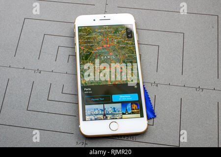 PARIS, FRANCE - SEP 26, 2016: Male hand holding New Apple iPhone 7 8 Plus smartphone after unboxing and testing by installing the app application software Apple Maps GPS flyover Paris France Stock Photo