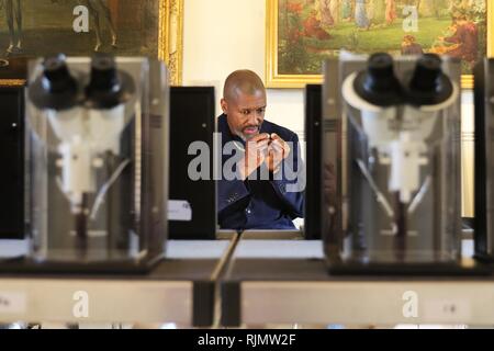 Micro artist Willard Wigan MBE who makes sculptures which fit within the eye of a needle, pictured at his exhibition in Broadway, Worcestershire. Stock Photo