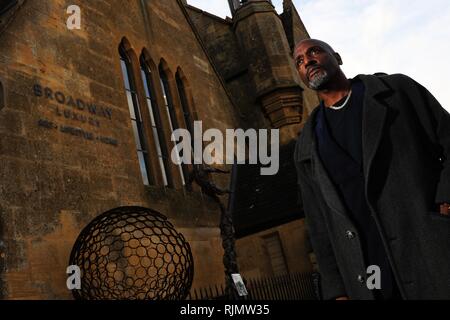 Micro artist Willard Wigan MBE who makes sculptures which fit within the eye of a needle, pictured at his exhibition in Broadway, Worcestershire. Stock Photo