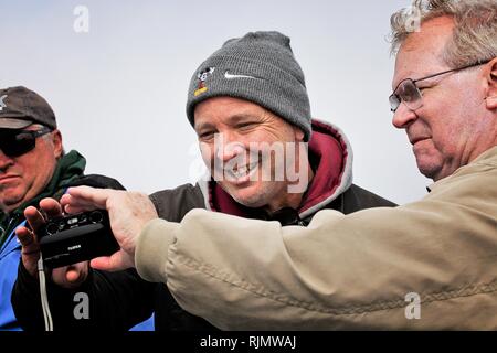 Friends looking at videos on camera Stock Photo