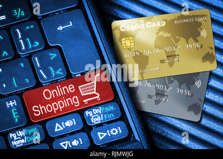 Close up of computer laptop keyboard on generic credit cards with red button Online Shopping concept. Idea of Internet shopping and data privacy, secu Stock Photo