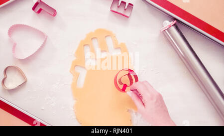 Step by step. Cutting out gift tags from brown paper with a paper punch  Stock Photo - Alamy