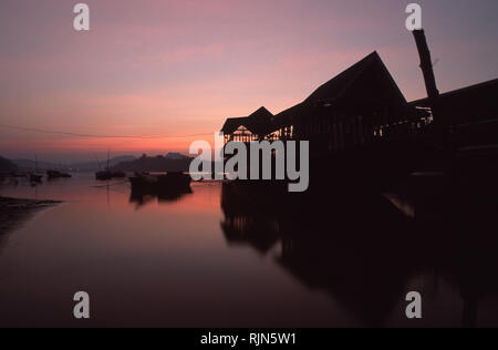 Caption: Luang Prabang, Laos - Jan 2001. A house-come-cargo boat at sunset on the Mekong in Laos. The traditional means of long distance transport, th Stock Photo