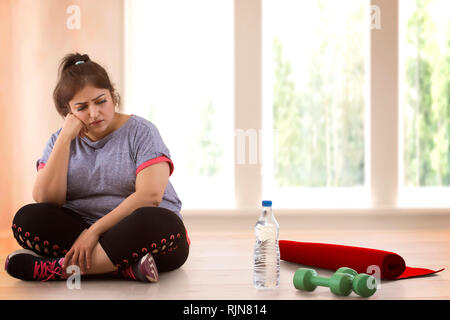 Fat nude woman sitting on the floor Stock Photo - Alamy