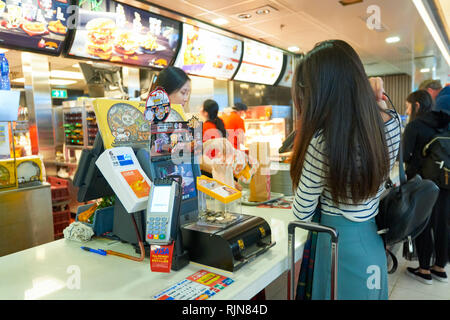 HONG KONG - MARCH 08, 2016: McDonald's restaurant in the Airport. McDonald's primarily sells hamburgers, cheeseburgers, chicken, french fries, breakfa Stock Photo