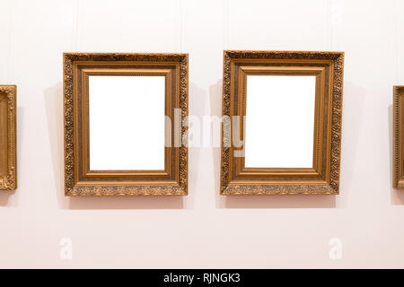 Blank empty frames hanging on museum wall. Art gallery, museum exhibition white clipping path Stock Photo