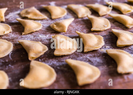 close up of homemade italian pasta ravioli over a wood table Stock Photo