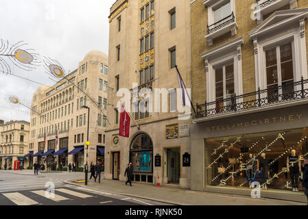 Corner between Old Bond Street and New Bond Street, Mayfair, with stores like Stella McCartney, Salvatore Ferragamo and Ralph Lauren. London, England Stock Photo
