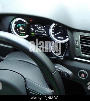 Speedometer arrow in reflection on the glass display of smartphone on the car dashboard under steering wheel Stock Photo