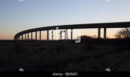 the road bridge connecting the isle of sheppey to  kent over the river swale england Stock Photo