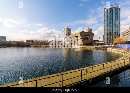 The Canada Water library seen across the Surrey Quays pond on a sunny day. London, England.